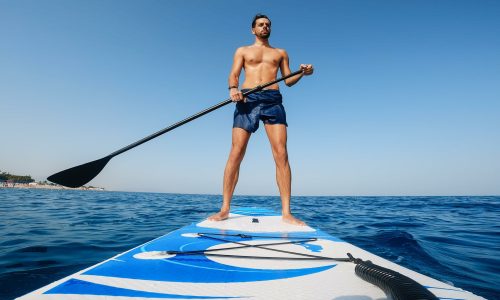 Low angle view of a man on stand up Paddle